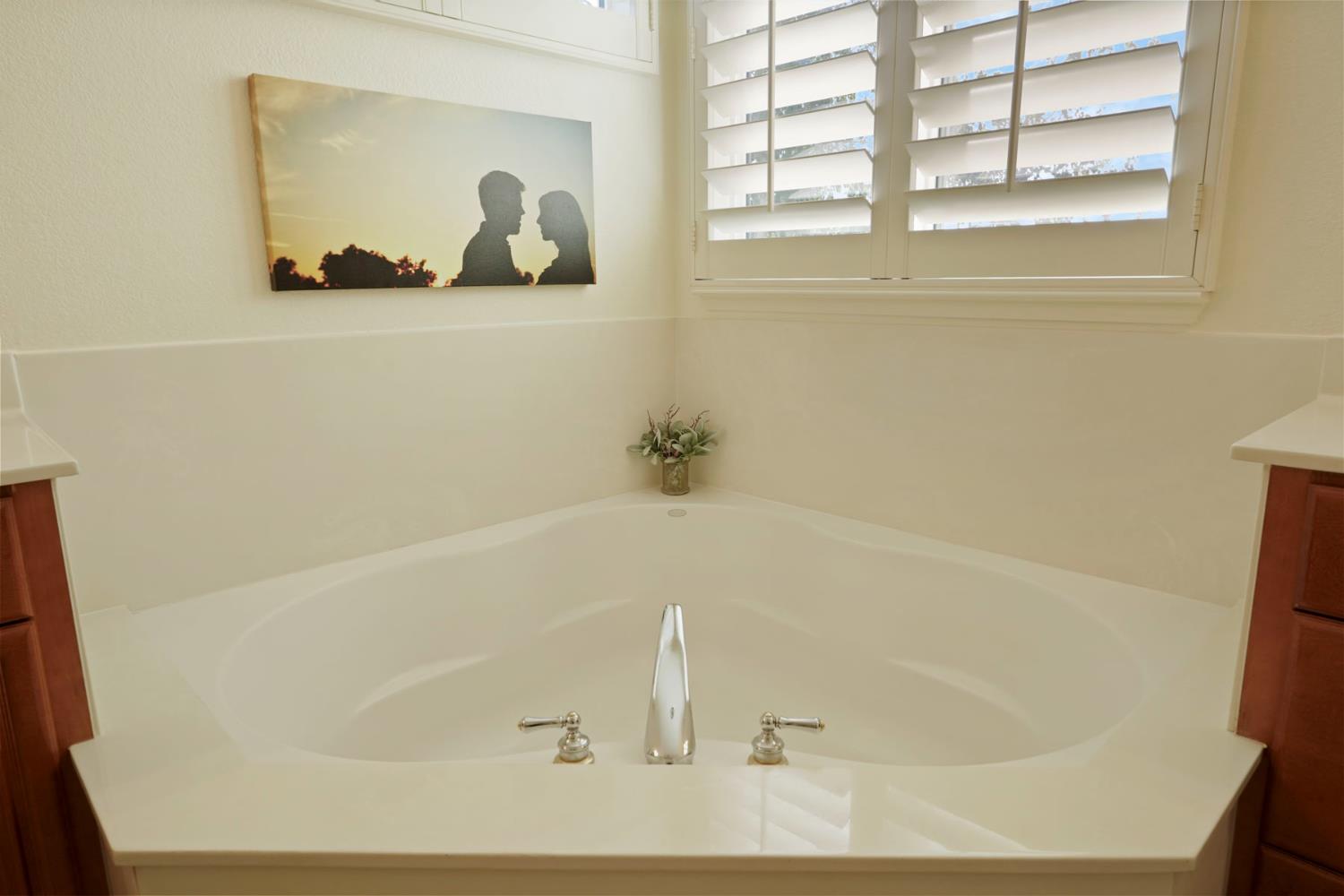 2227 Heavenly Way Lodi, CA 95242 - Photo 42 of 62 a white tub sitting next to a window