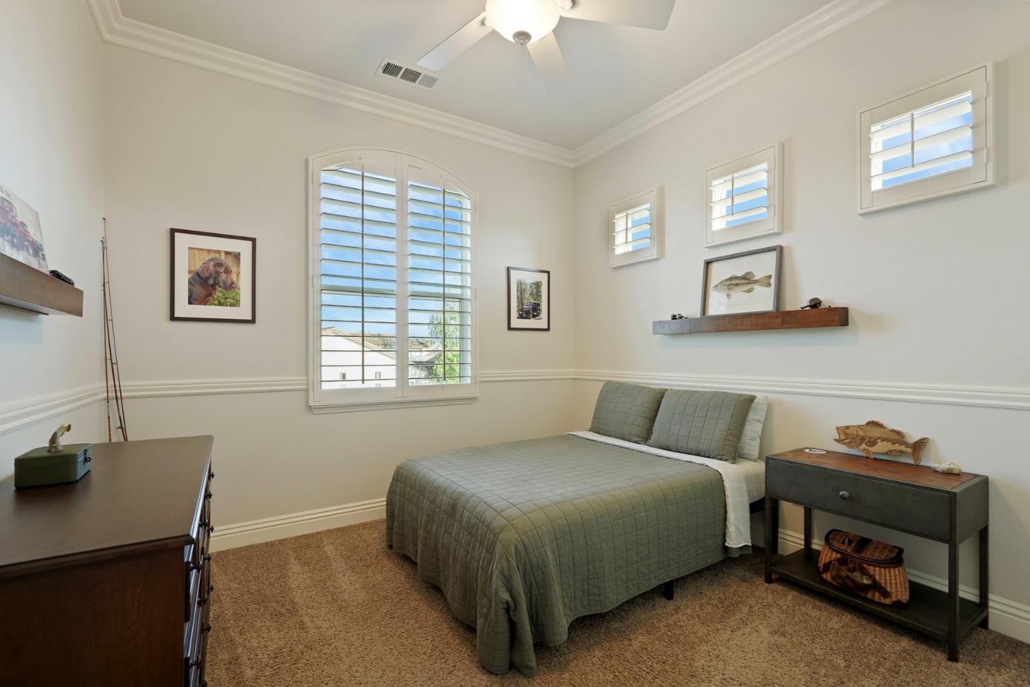 2227 Heavenly Way Lodi, CA 95242 - Photo 48 of 62 a bedroom with a bed and a chandelier