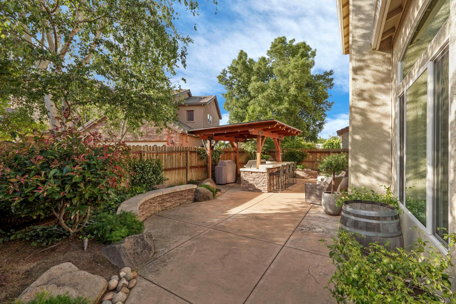 2227 Heavenly Way Lodi, CA 95242 - Photo 53 of 62 a view of a patio with table and chairs under an umbrella