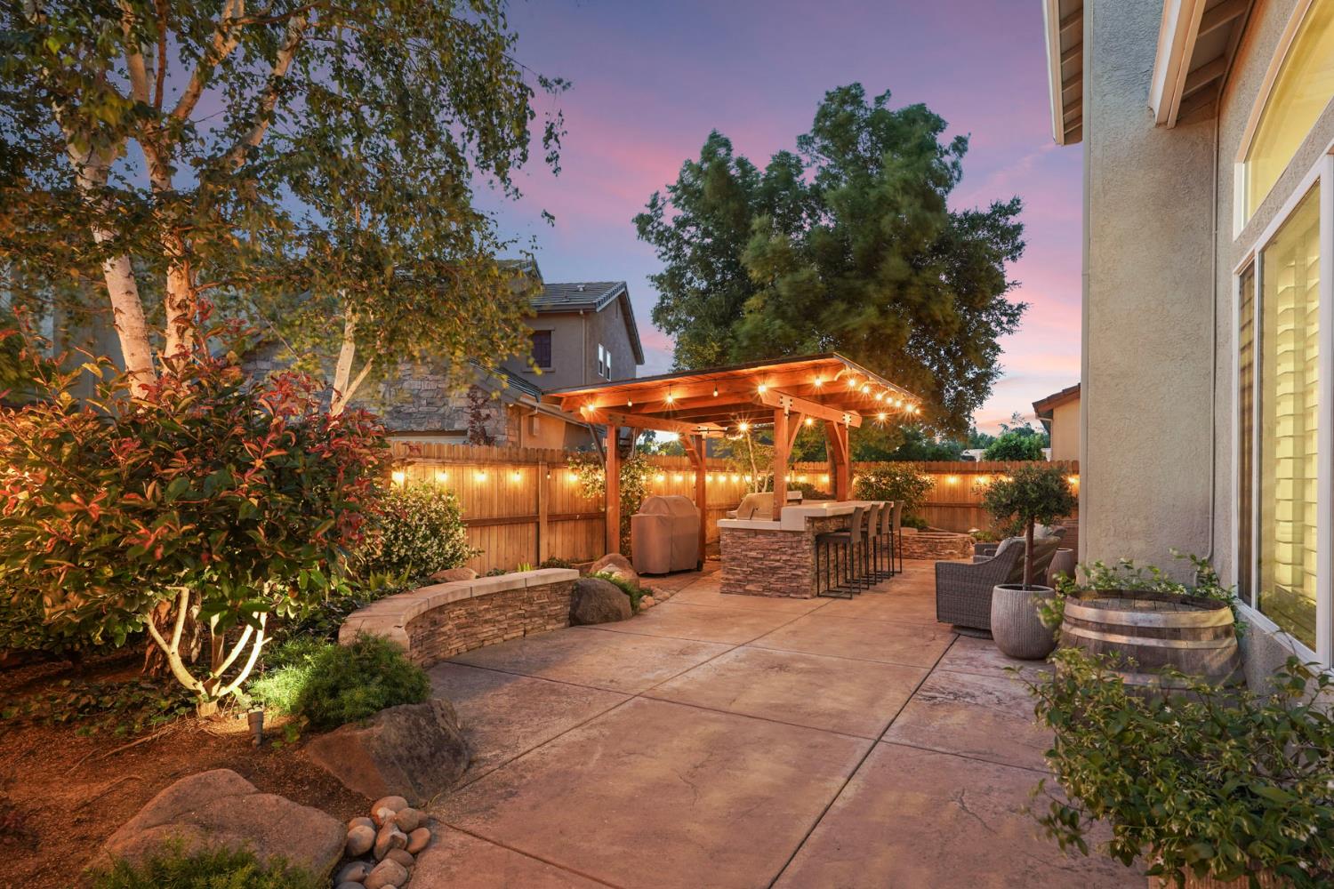 2227 Heavenly Way Lodi, CA 95242 - Photo 57 of 62 a view of a patio with table and chairs under an umbrella