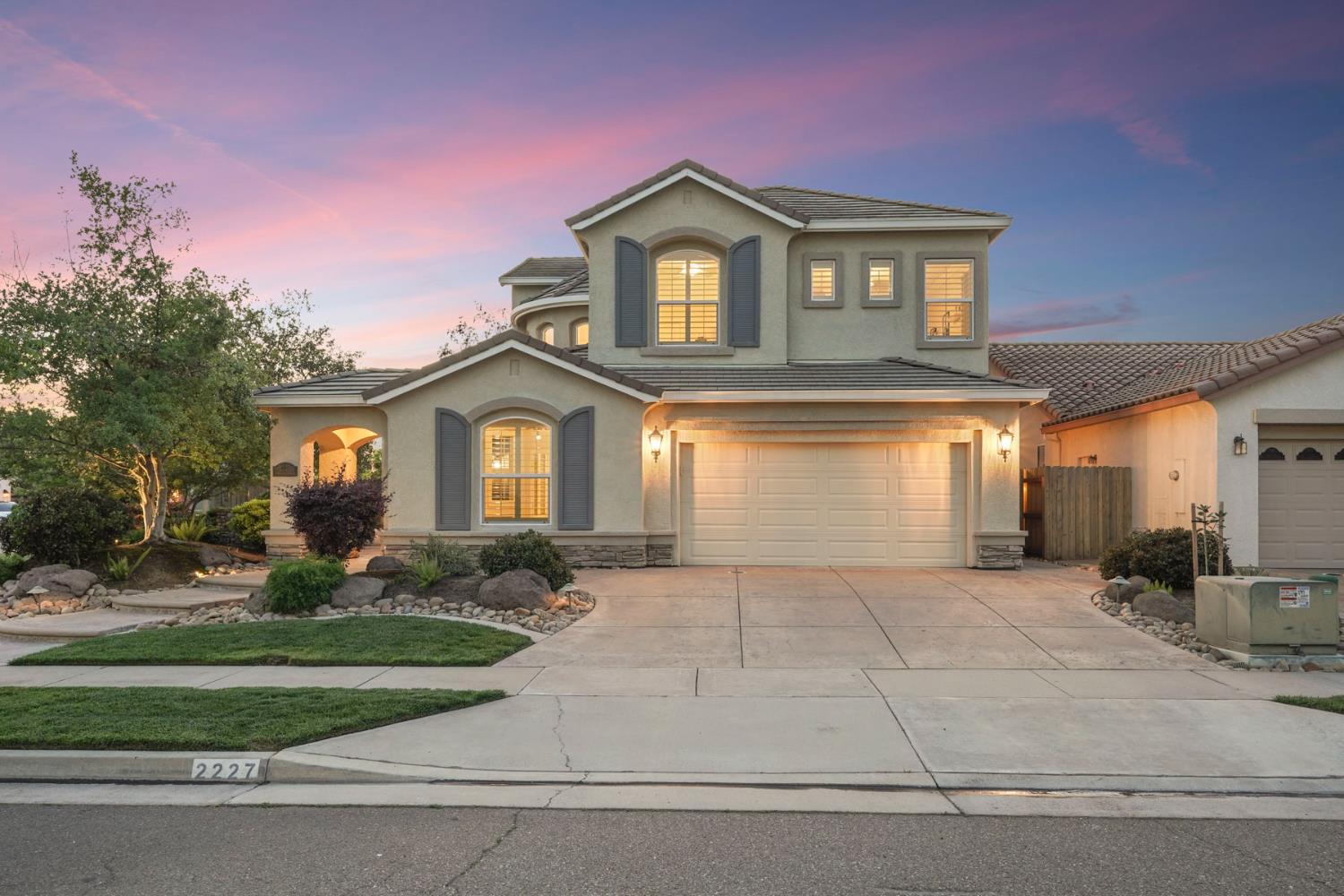 2227 Heavenly Way Lodi, CA 95242 - Photo 6 of 62 a front view of a house with a yard and garage