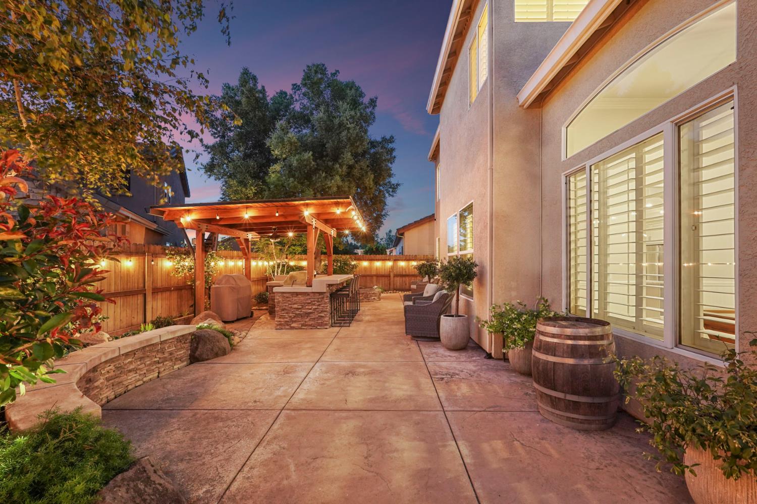 2227 Heavenly Way Lodi, CA 95242 - Photo 62 of 62 a view of a patio with dining table and chairs and potted plants