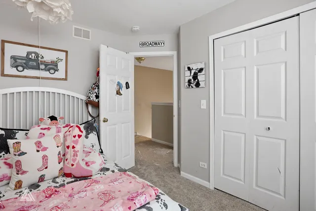 a bedroom with baby bed and hallway