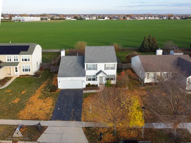 an aerial view of a house with garden space and lake view