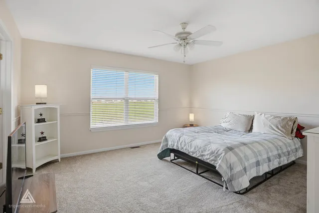 a spacious bedroom with a bed a window and closet