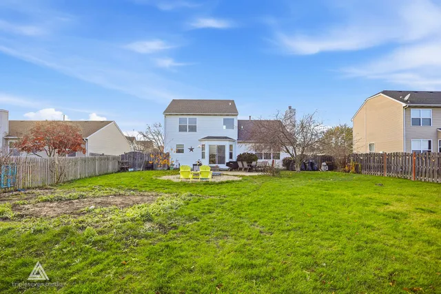 a house view with a big yard plants and large trees
