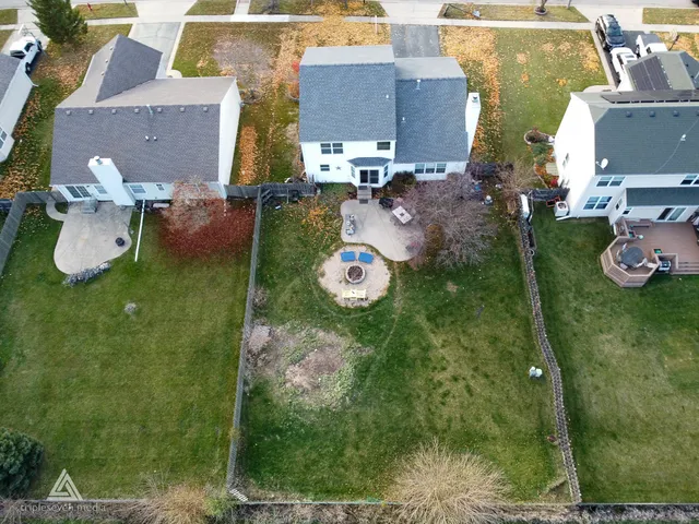 an aerial view of a house with garden space and street view