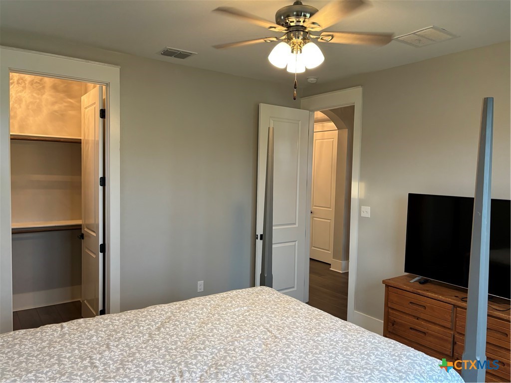 110 Hiram Cook Blanco, TX 78606 - Photo 11 of 46 a bedroom with a bed and a flat tv screen on dresser