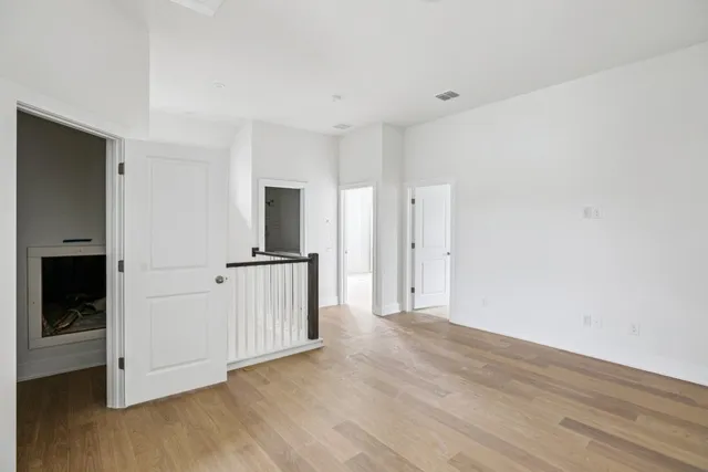 a view of a room with wooden floor