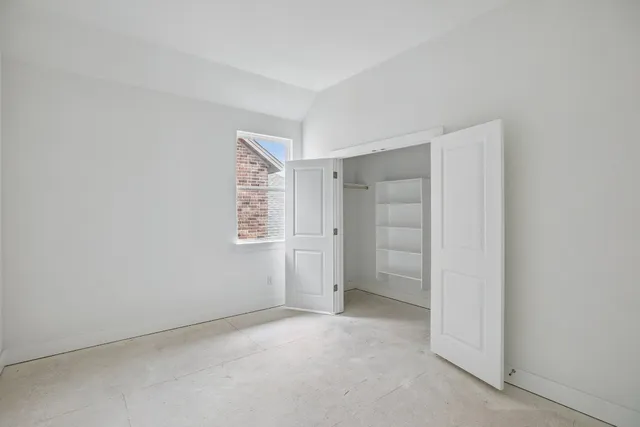 an empty room with closet area