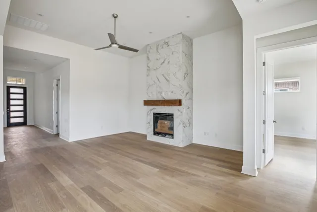 a view of a livingroom with a fireplace and chandelier