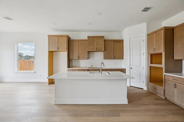 a view living room with stainless steel appliances granite countertop cabinets and a wooden floor