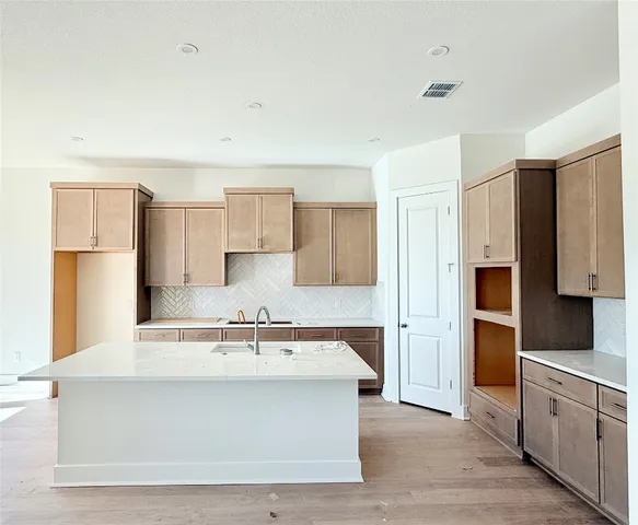 a view white kitchen with stainless steel appliances cabinets