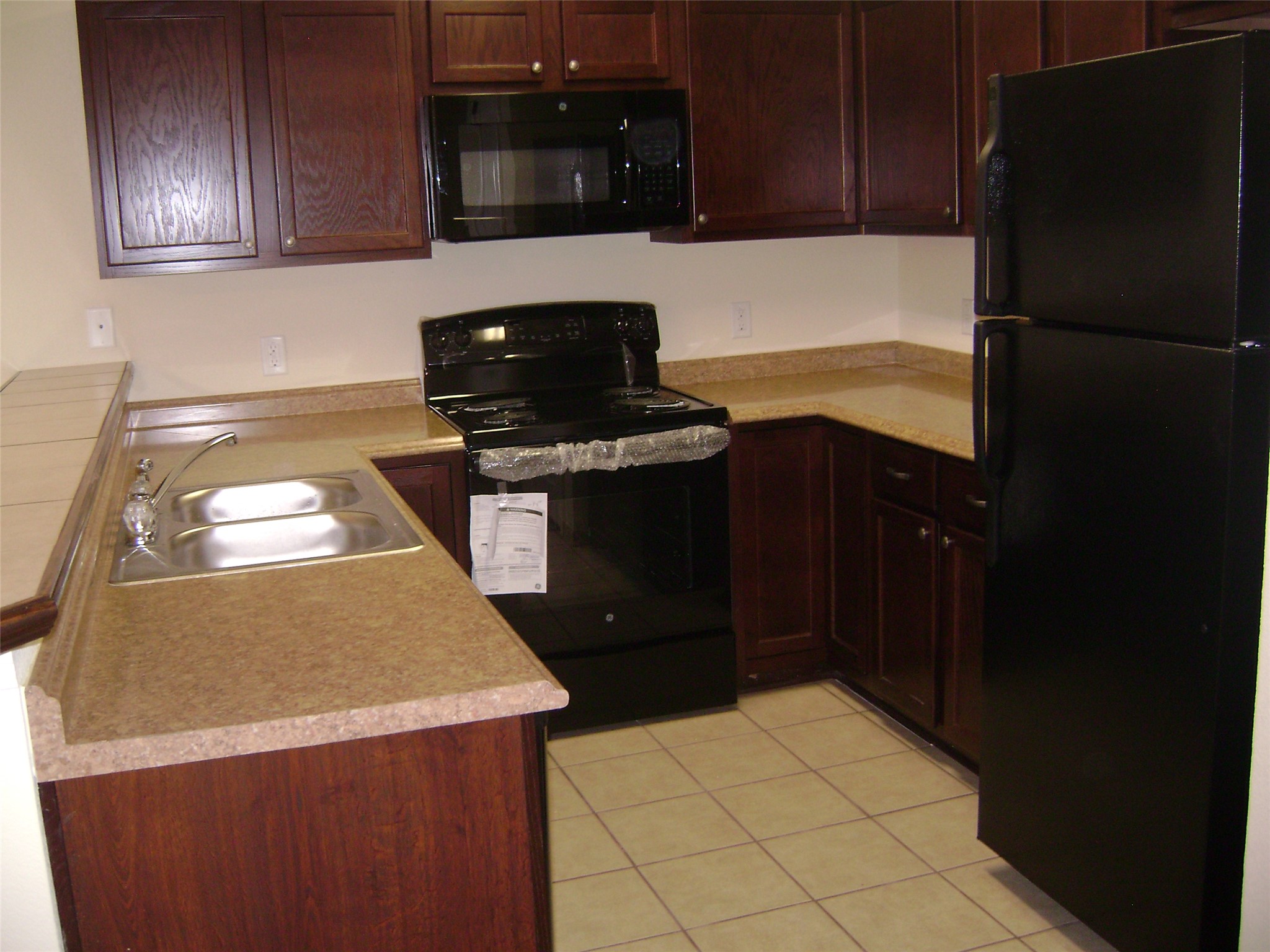 2507 Oak Lane, Unit A Georgetown, TX 78628 - Photo 4 of 11 A well-appointed kitchen showcasing rich cabinetry and practical counter space.