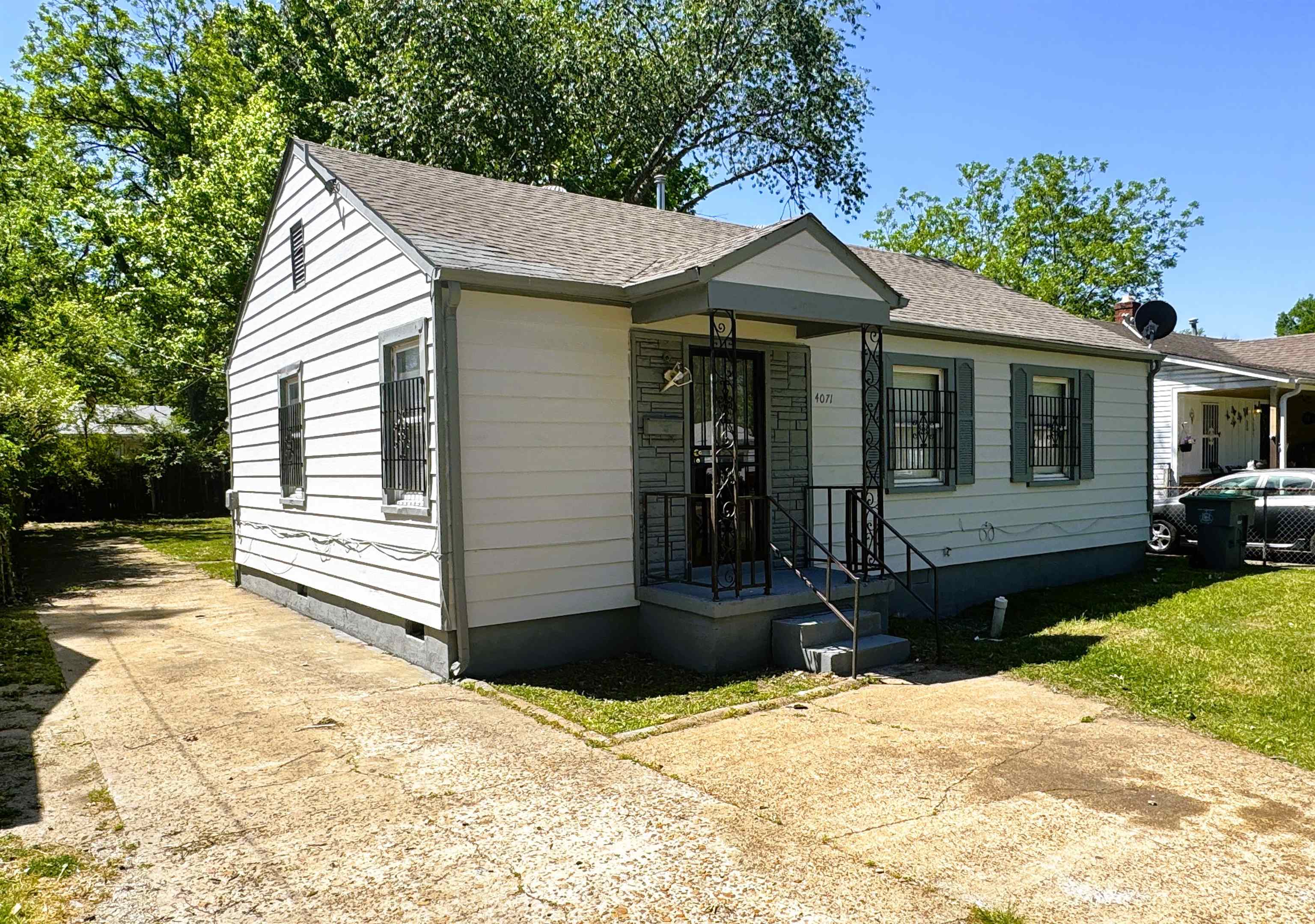 4071 Grey Road Memphis, TN 38108 - Photo 2 of 15 a front view of a house with a yard and potted plants