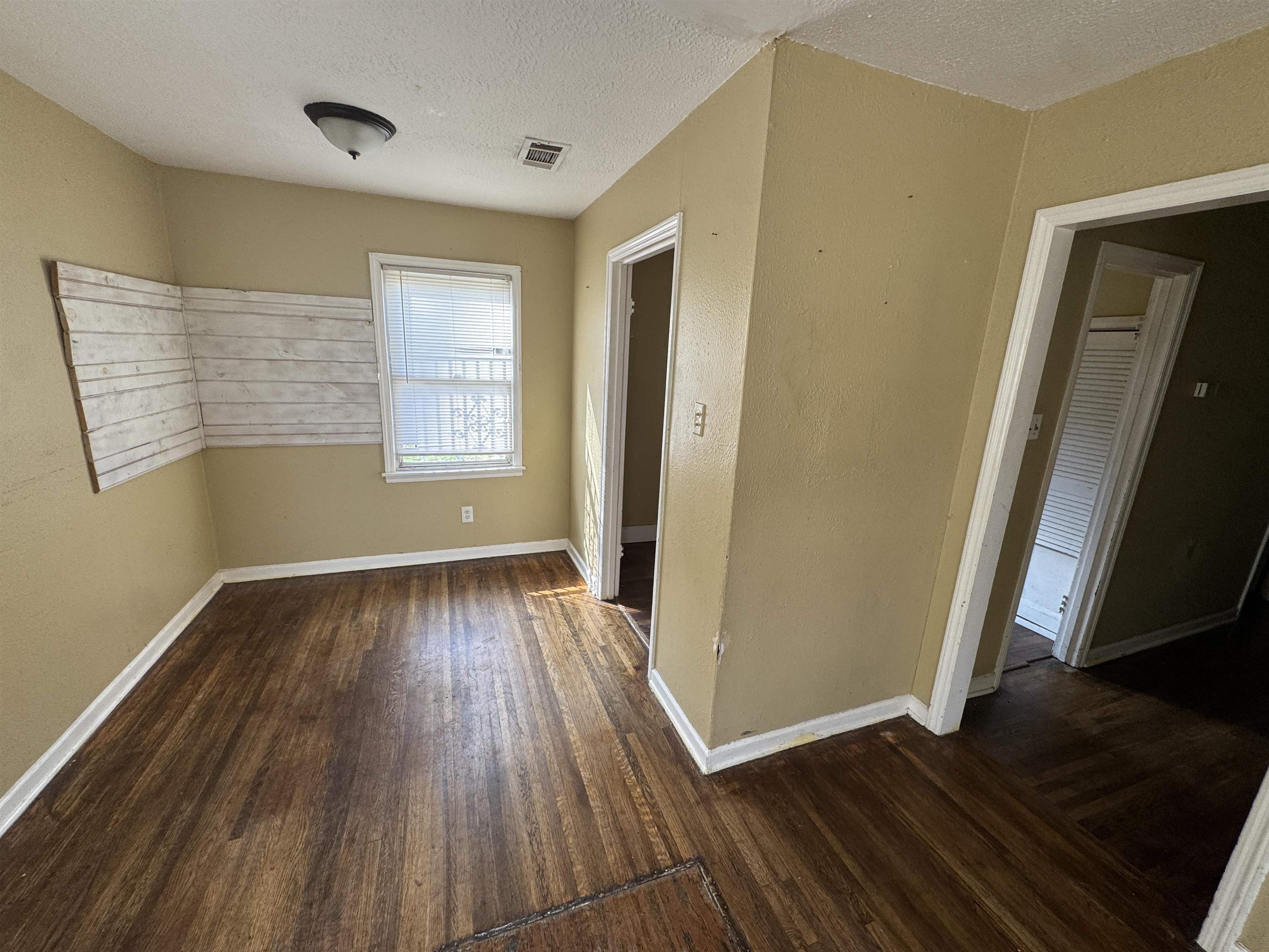 4071 Grey Road Memphis, TN 38108 - Photo 3 of 8 Interior space with dark wood finished floors and a textured ceiling