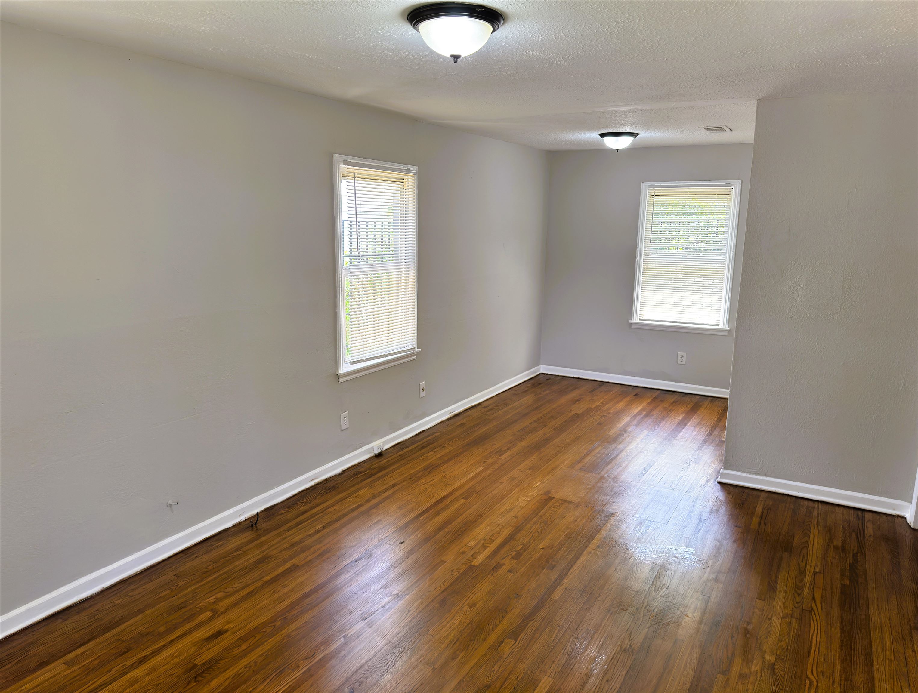 4071 Grey Road Memphis, TN 38108 - Photo 3 of 15 a view of an empty room with wooden floor and a window