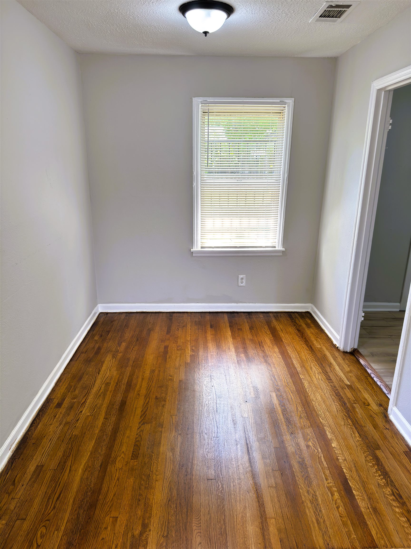4071 Grey Road Memphis, TN 38108 - Photo 4 of 15 a view of a room with wooden floor and a window