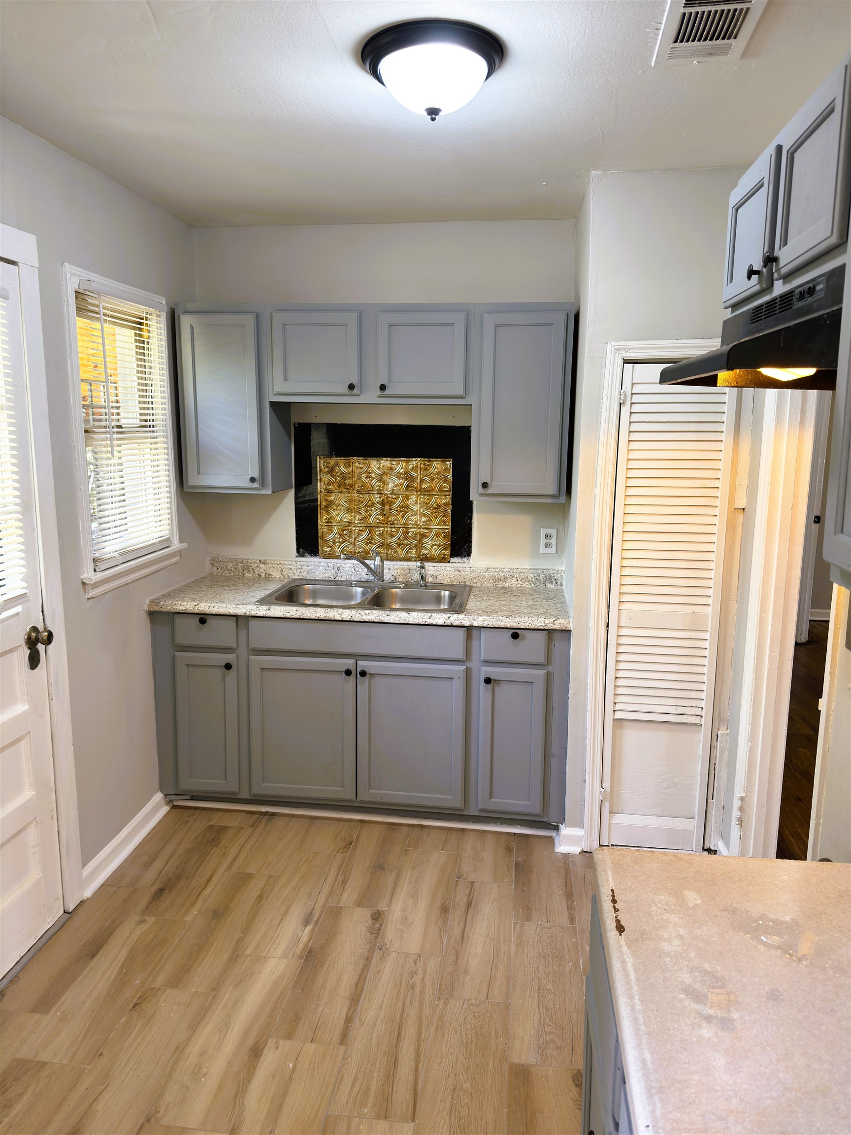 4071 Grey Road Memphis, TN 38108 - Photo 5 of 15 a kitchen with stainless steel appliances a refrigerator sink and microwave