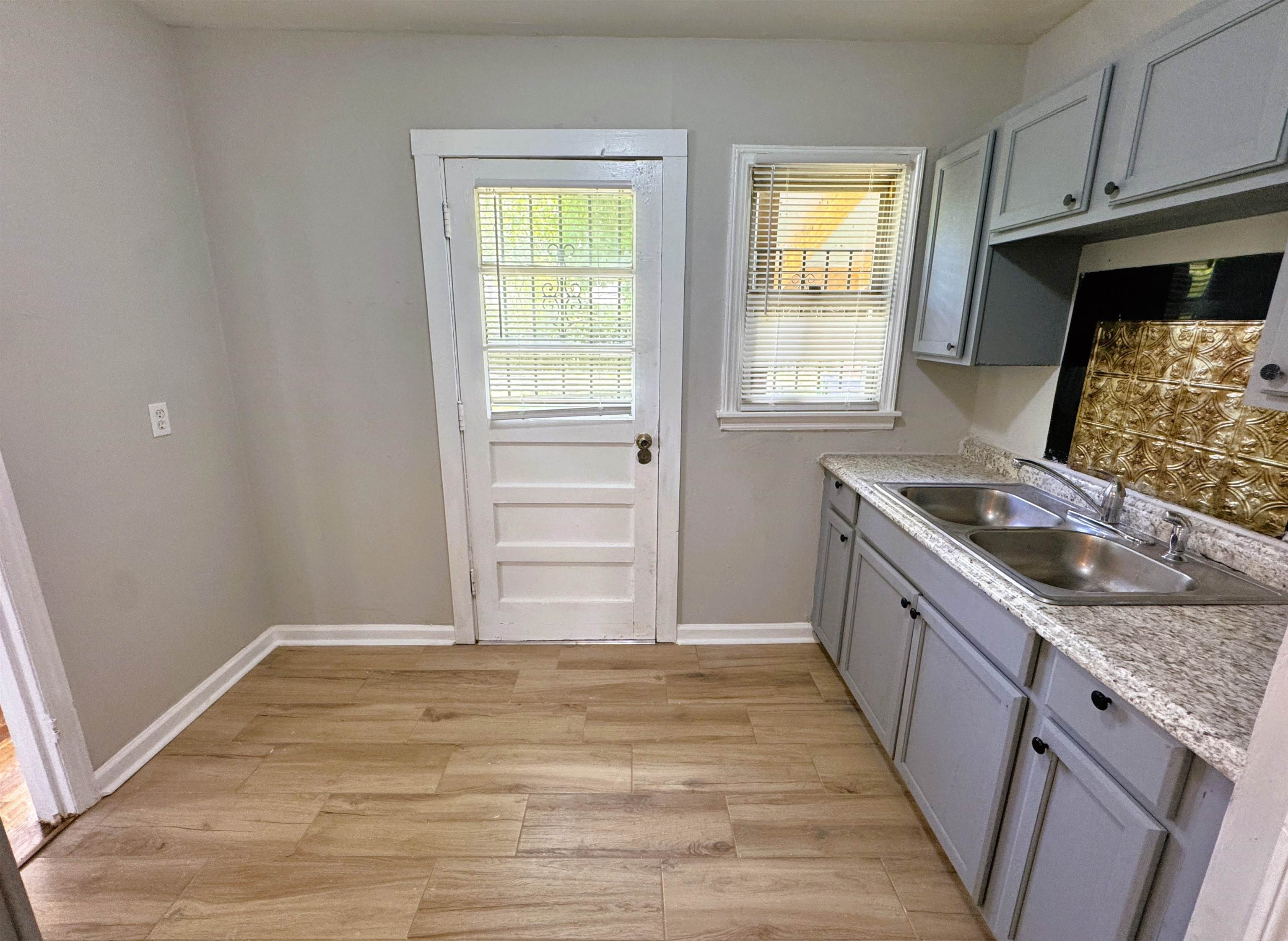 4071 Grey Road Memphis, TN 38108 - Photo 7 of 15 a kitchen with granite countertop a sink and a stove top oven
