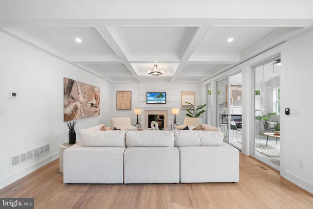 a living room with furniture fireplace and rug