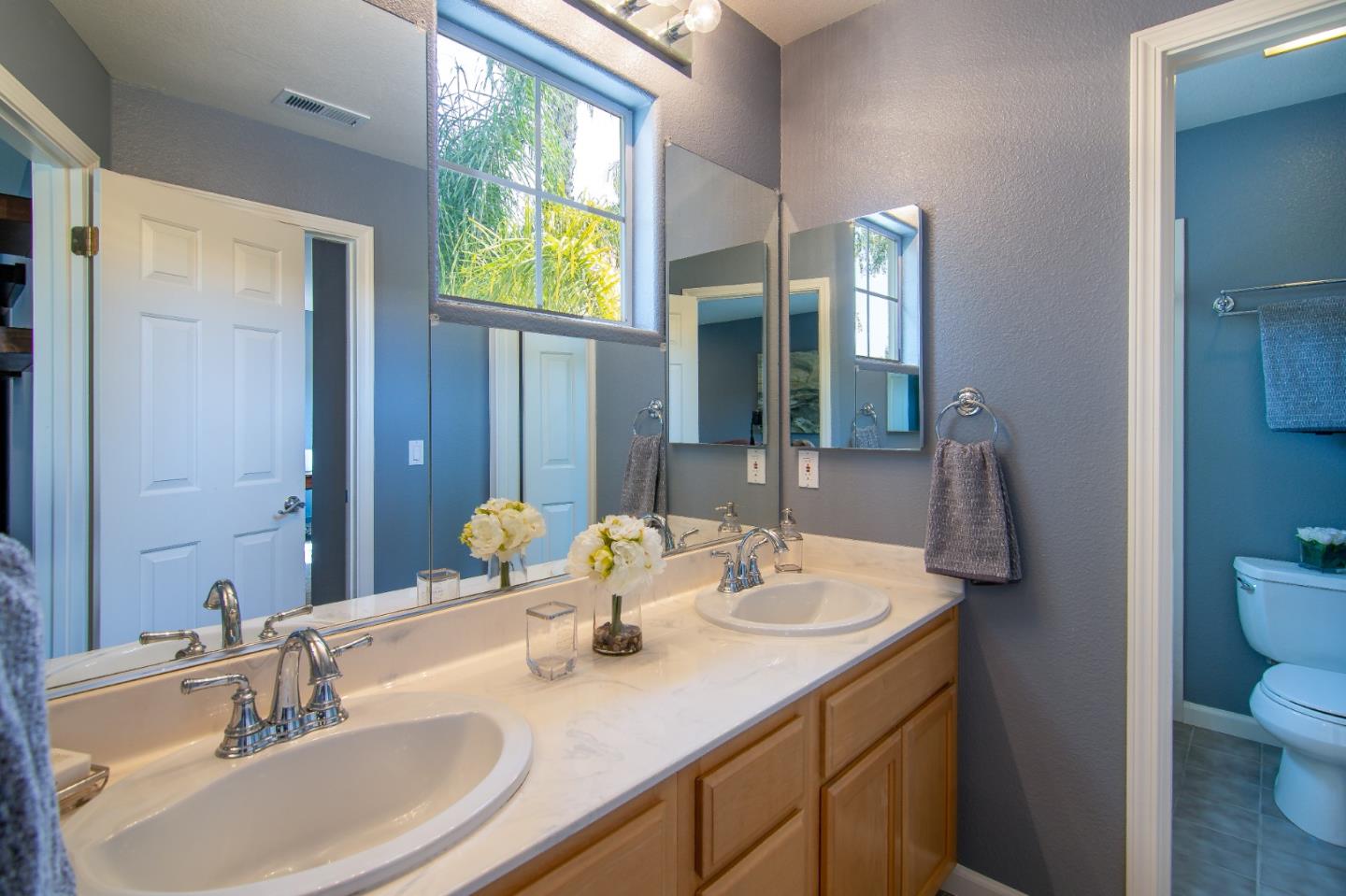 5871 Killarney Circle San Jose, CA 95138 - Photo 18 of 33 a bathroom with 2 sink and a mirror