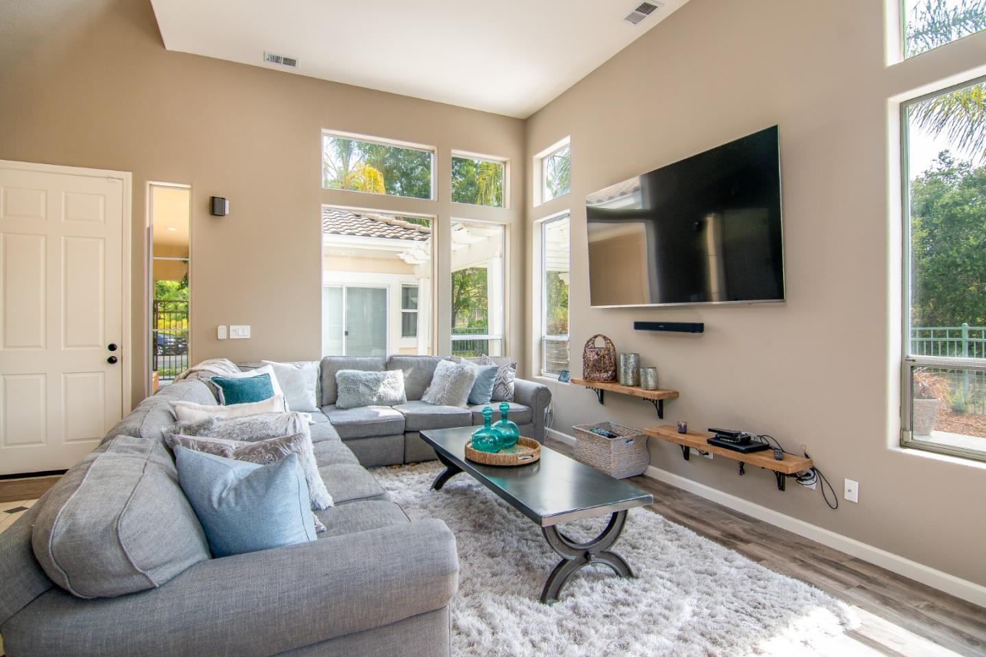 5871 Killarney Circle San Jose, CA 95138 - Photo 4 of 33 a living room with furniture a flat screen tv and a large window