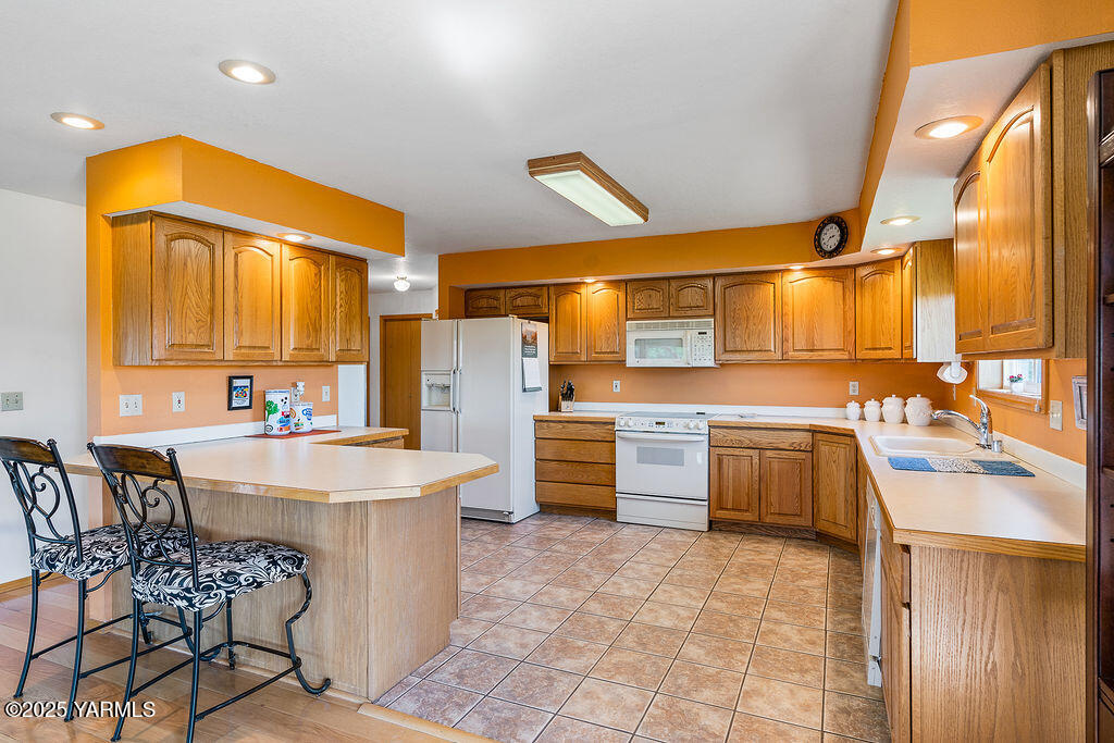 360 Orchardvale Road Zillah, WA 98953 - Photo 11 of 31 a kitchen with stainless steel appliances a sink cabinets and wooden floor