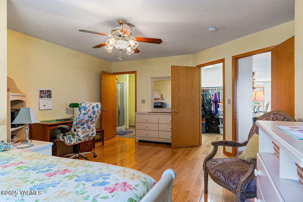 360 Orchardvale Road Zillah, WA 98953 - Photo 17 of 31 a bedroom with bed and wooden floor