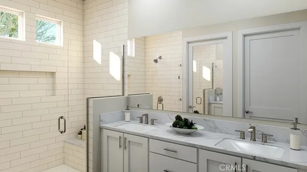 a bathroom with a granite countertop sink a mirror and a shower