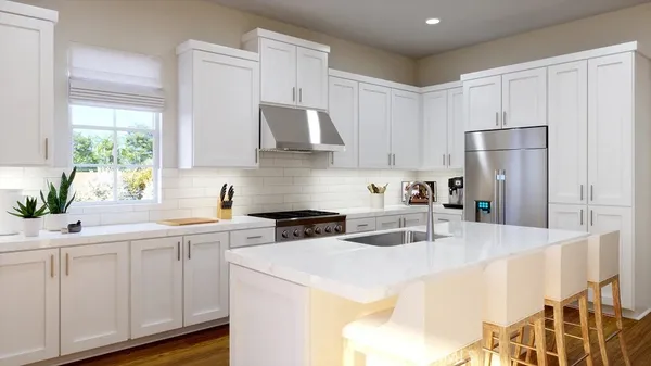 a kitchen with stainless steel appliances a sink a stove a refrigerator and cabinets