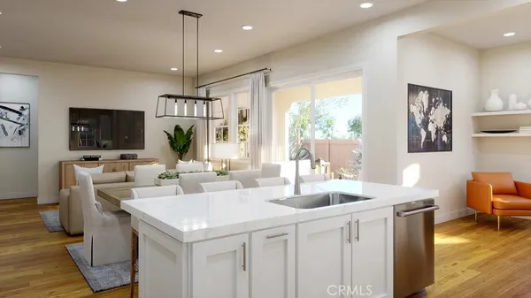 a kitchen with a sink a center island and couches