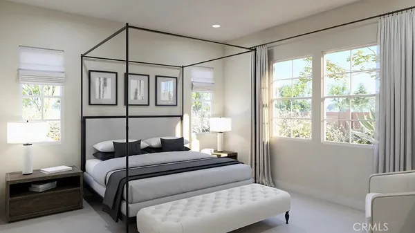 a bedroom with a bed mirror and a window