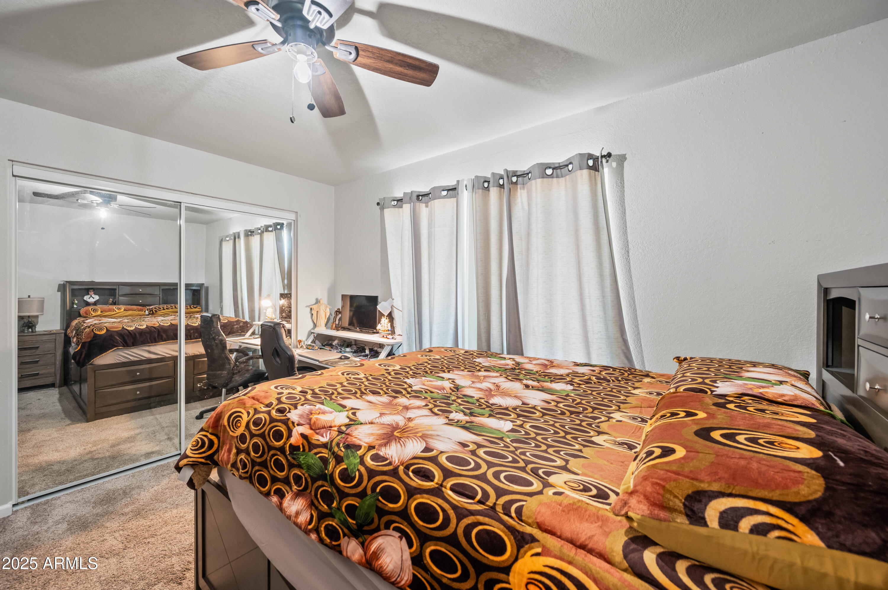 7231 West Flower Street Phoenix, AZ 85033 - Photo 12 of 17 a bedroom with a bed and a chandelier