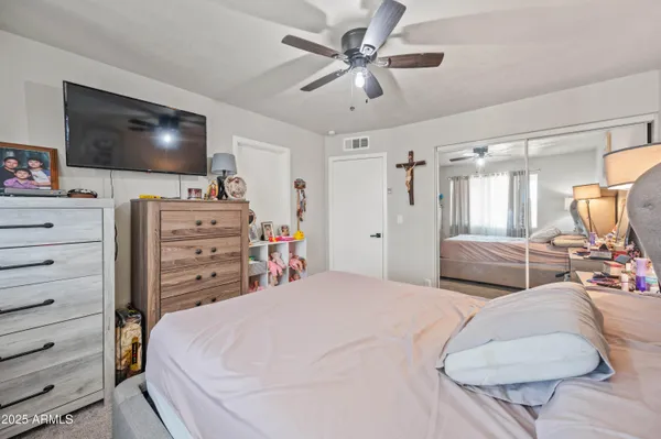 a bedroom with a bed and a flat screen tv