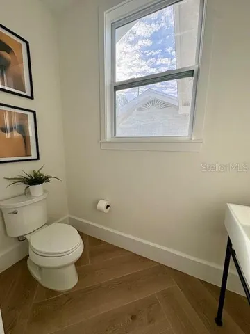 a white toilet sitting next to a bathroom sink