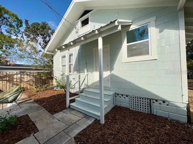 a view of a house with a small yard