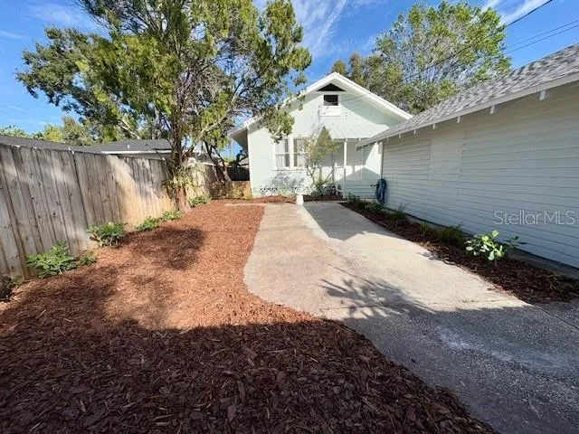 a view of backyard of house with green space