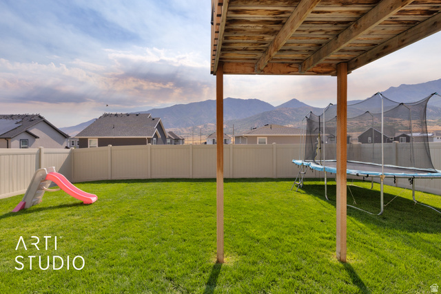 1713 South Windemere Road Santaquin, UT 84655 - Photo 28 of 40 Expansive backyard featuring a green lawn, privacy fencing, and a mountain backdrop
