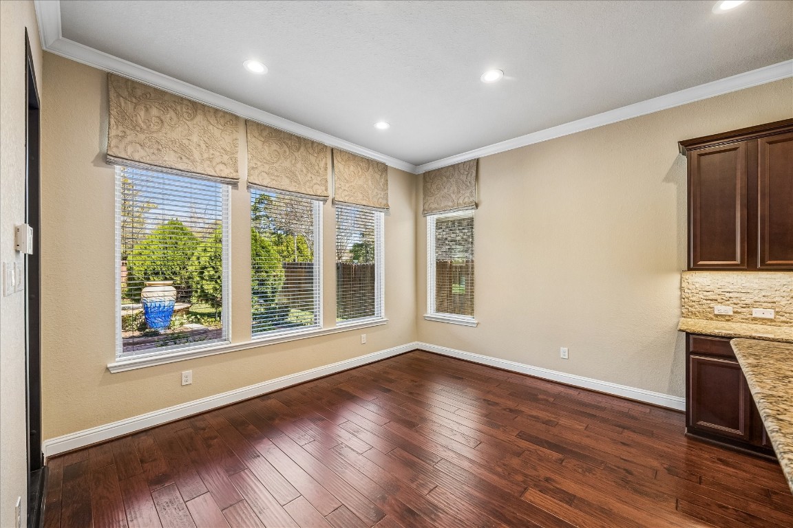 14123 Spindle Arbor Road Cypress, TX 77429 - Photo 15 of 45 The breakfast room features large windows offering a view of the landscaped backyard . It has rich hardwood floors and neutral walls.