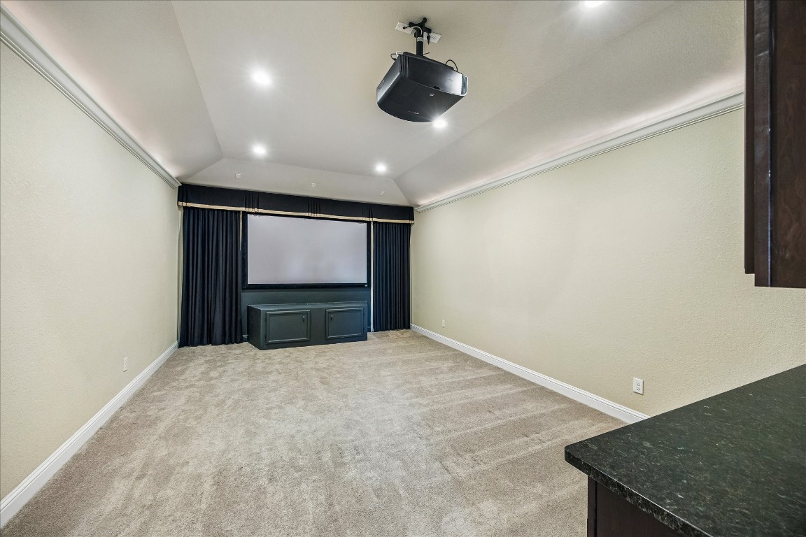 14123 Spindle Arbor Road Cypress, TX 77429 - Photo 28 of 45 Carpeted home theater room featuring a large screen, ceiling-mounted projector, and recessed lighting. Perfect for movie nights and entertainment.