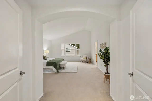 a bedroom with a bed and a potted plant on th dresser