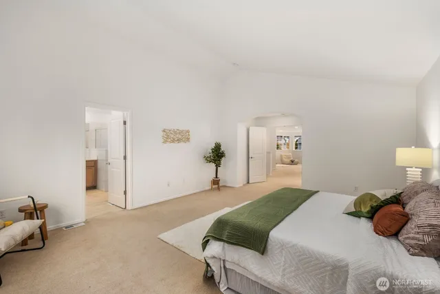 a bedroom with a bed and a couch