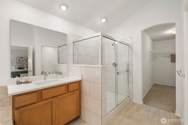 a bathroom with a shower sink and mirror