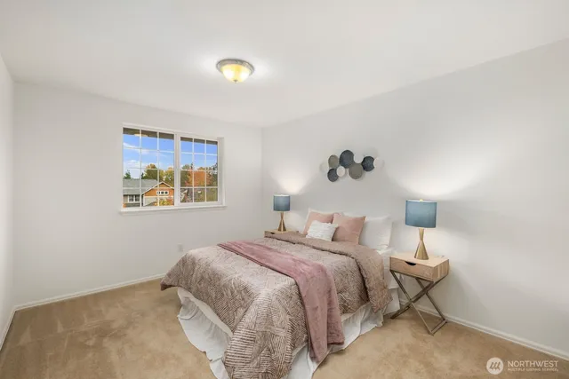 a bedroom with a bed and a painting on the wall