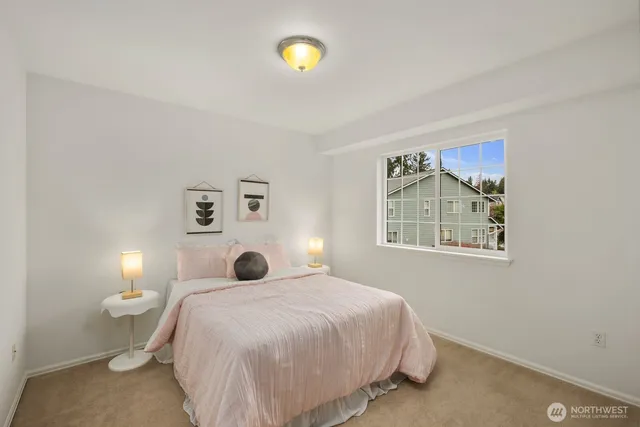 a bedroom with a bed and painting on the wall