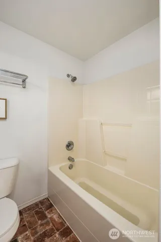 a bathroom with a bathtub and toilet