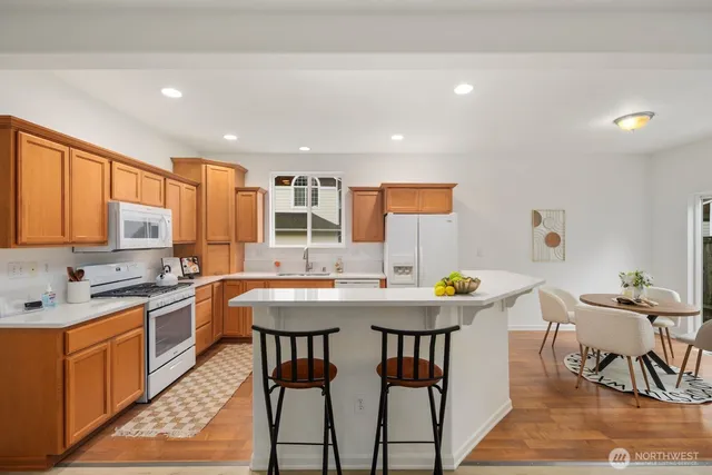 a kitchen with stainless steel appliances granite countertop a stove a sink and a refrigerator