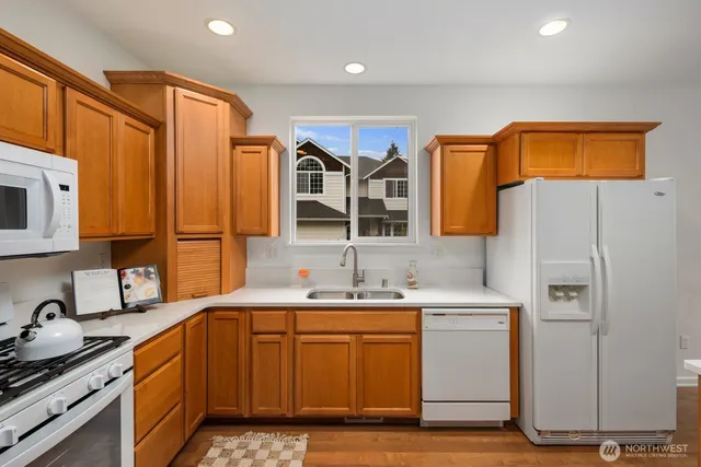 a kitchen with a sink a refrigerator and cabinets