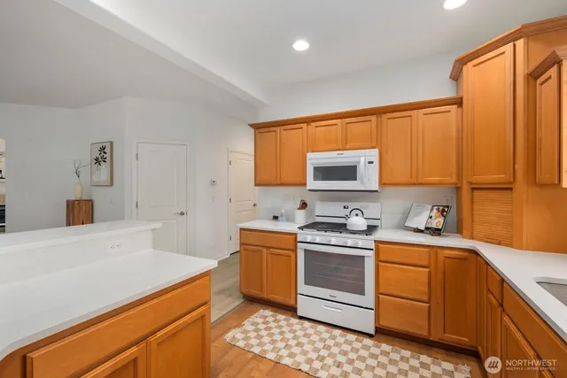a kitchen with a sink stove and cabinets